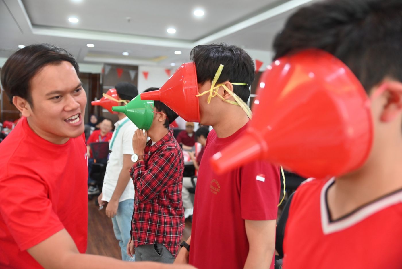 Team members playing a funnel game during the office Independence Day celebration