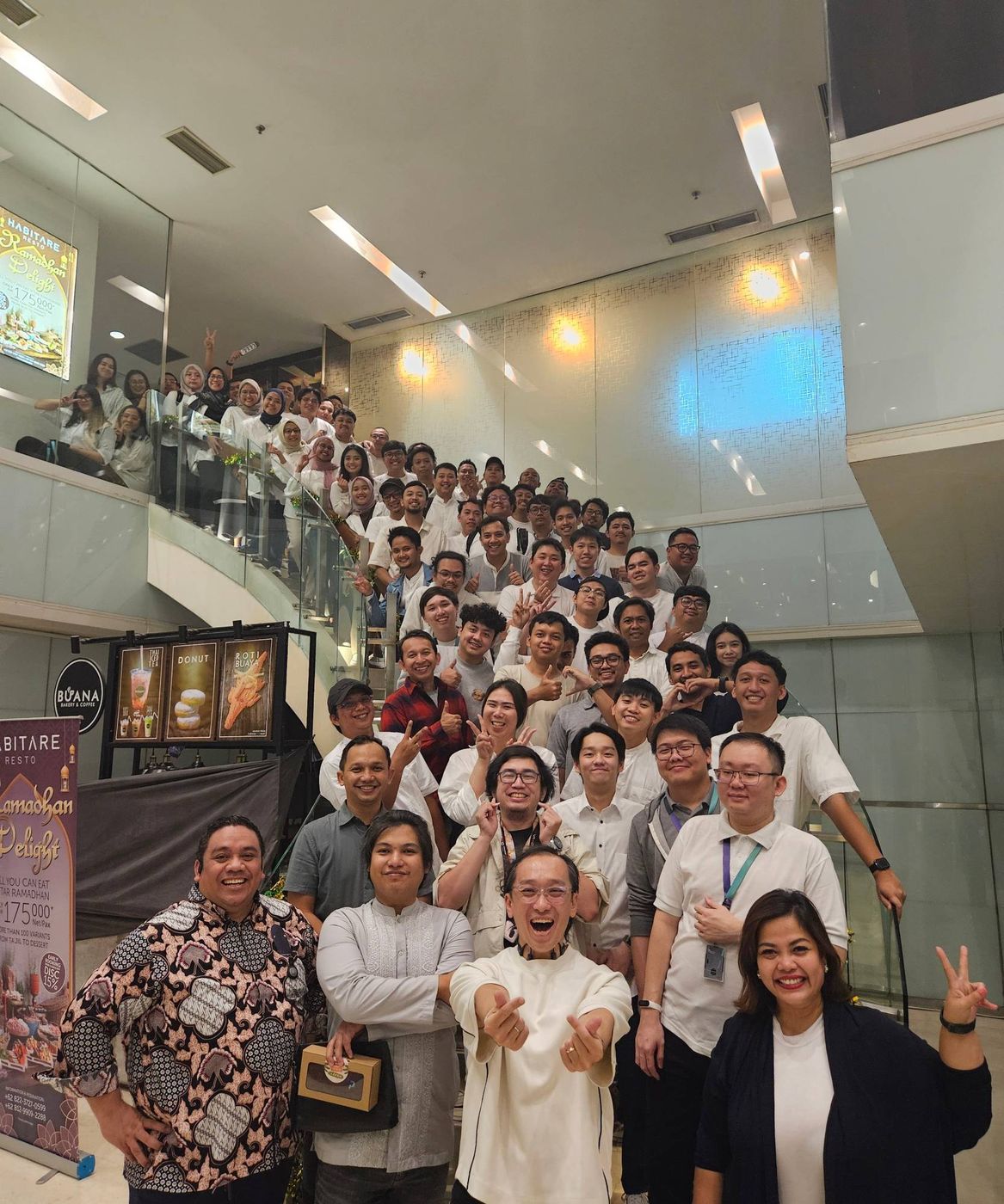 The DDT team lined up on a staircase for a group photo at a Ramadan iftar